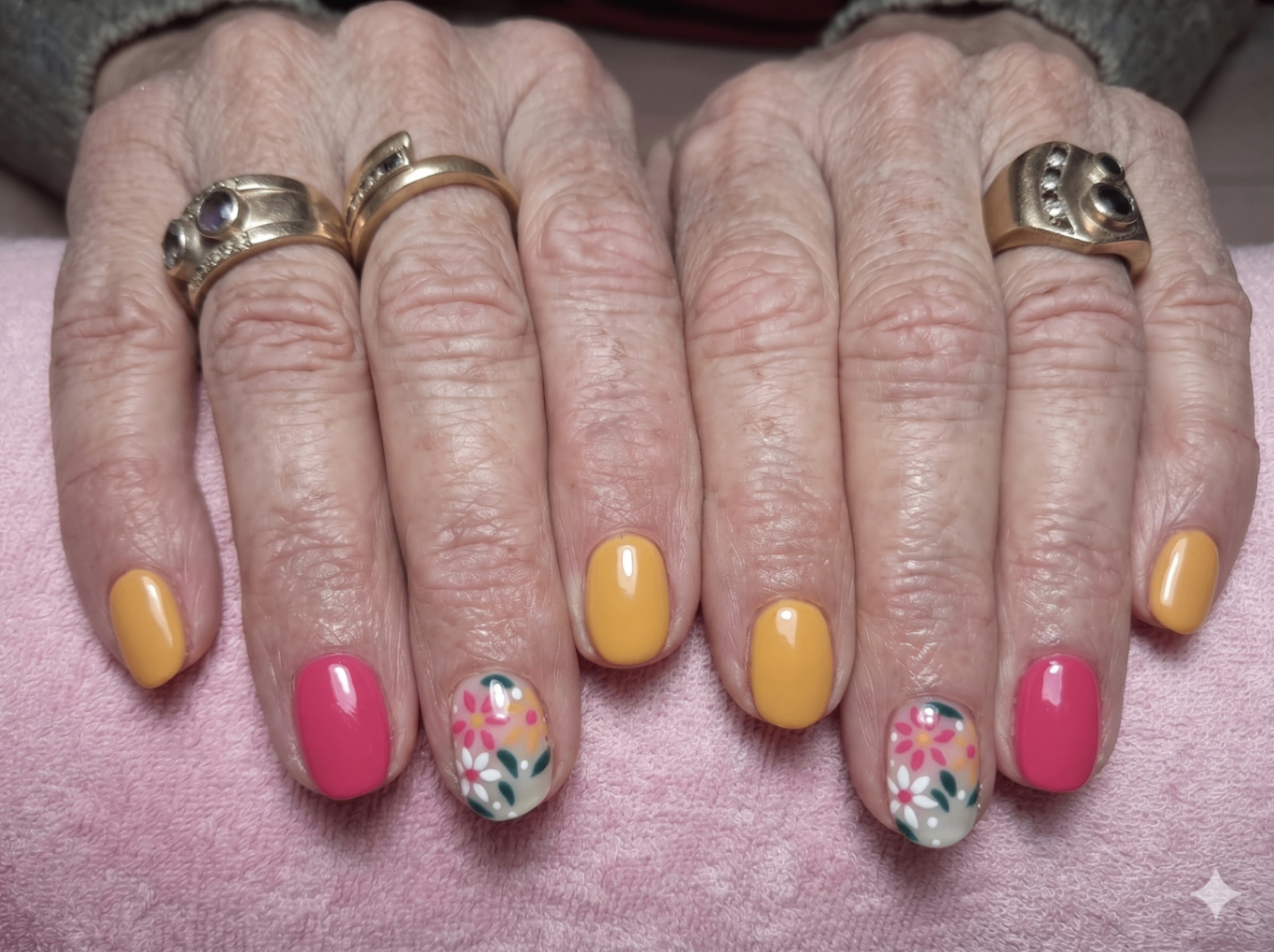 Yellow and pink nails with floral accent